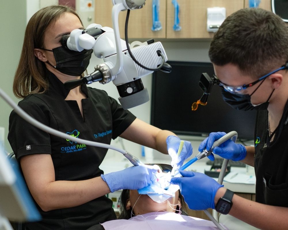 Dr. Regina Yunusov performing root canal procedure with high-magnification microscope
